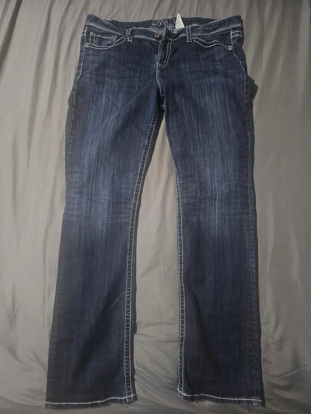 Dark wash denim jeans contrast stitching faded whiskering back pocket detailing